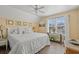 Bright bedroom with a ceiling fan, wooden floors, and a comfortable queen-size bed at 1608 25Th Ave. N, North Myrtle Beach, SC 29582