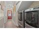 Hallway with a laundry area and a view of the home's entry door at 1608 25Th Ave. N, North Myrtle Beach, SC 29582