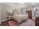 Comfortable main bedroom with a tufted headboard, soft lighting, and a large window at 1608 25Th Ave. N, North Myrtle Beach, SC 29582