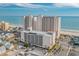 An aerial view of beachfront condo towers, parking garage, surrounding neighborhood and ocean view at 1625 S Ocean Blvd. # 1004, North Myrtle Beach, SC 29582