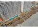 Aerial view of condo complex featuring pool, spa, beach access and ocean view at 1625 S Ocean Blvd. # 1004, North Myrtle Beach, SC 29582