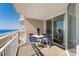 Enjoy ocean views from this condo balcony with table and chairs at 1625 S Ocean Blvd. # 1004, North Myrtle Beach, SC 29582