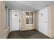 Condo hallway featuring entry doors, showing unit numbers, neutral color palette, and a small window at 1625 S Ocean Blvd. # 1004, North Myrtle Beach, SC 29582