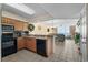 Modern kitchen seamlessly flows into living area, granite countertops, and updated black appliances at 1625 S Ocean Blvd. # 1004, North Myrtle Beach, SC 29582
