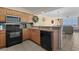 Kitchen with granite countertops, stainless steel appliances, and bar seating adjacent to the living area at 1625 S Ocean Blvd. # 1004, North Myrtle Beach, SC 29582