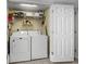Functional laundry room with a washer, dryer, and shelving for convenient storage at 1625 S Ocean Blvd. # 1004, North Myrtle Beach, SC 29582