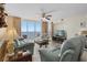 Bright living room featuring comfortable seating, ceiling fan, and a balcony offering beautiful ocean views at 1625 S Ocean Blvd. # 1004, North Myrtle Beach, SC 29582