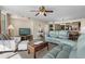 Comfortable living room featuring tile flooring, ceiling fan, and plush blue seating at 1625 S Ocean Blvd. # 1004, North Myrtle Beach, SC 29582