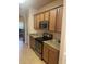 Functional kitchen with stainless steel appliances, tile flooring, and stone countertops at 1719 Low Country Pl. # B, Myrtle Beach, SC 29577