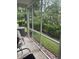A screened porch has outdoor furniture and a peaceful view of the green backyard at 1719 Low Country Pl. # B, Myrtle Beach, SC 29577