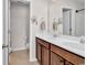 Bathroom featuring a double sink vanity with warm wood cabinets and a large mirror at 1749 Culbertson Ave. # 1749, Myrtle Beach, SC 29577
