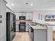 Stylish kitchen with gray cabinets, stainless steel appliances, and a breakfast bar at 1749 Culbertson Ave. # 1749, Myrtle Beach, SC 29577