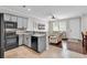 Bright, open kitchen with an eat-in bar, gray cabinets, stainless appliances, and hardwood floors at 1749 Culbertson Ave. # 1749, Myrtle Beach, SC 29577