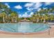 A zero entry community pool featuring palm trees, lounge chairs, and a blue sky backdrop at 1749 Culbertson Ave. # 1749, Myrtle Beach, SC 29577