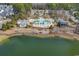 Aerial view of a large community pool, surrounding buildings, and a lake at 1749 Culbertson Ave. # 1749, Myrtle Beach, SC 29577