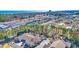 Aerial view of brick homes with lush trees, a pond, and local attractions in the distance at 2019 Balfour Ct. # L4, Myrtle Beach, SC 29575