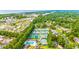 Expansive aerial view of a community showcasing tennis courts, swimming pool, and residential area near a coastal highway at 2019 Balfour Ct. # L4, Myrtle Beach, SC 29575