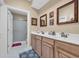 Bright bathroom with double sinks, wood cabinets, and a shower at 2019 Balfour Ct. # L4, Myrtle Beach, SC 29575