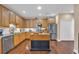Well-lit kitchen with an island, wooden cabinets, stainless steel appliances, and granite countertops at 2019 Balfour Ct. # L4, Myrtle Beach, SC 29575