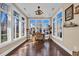 Bright sun room with large windows, hardwood floors, and unique chandelier at 2019 Balfour Ct. # L4, Myrtle Beach, SC 29575