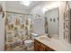Bright bathroom featuring a skylight, decorative accents, and a beach themed shower curtain at 206B 56Th Ave. N, North Myrtle Beach, SC 29582