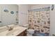 Bathroom with a light countertop, a wood-grain vanity, and a tropical themed shower curtain at 206B 56Th Ave. N, North Myrtle Beach, SC 29582