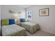 Bright bedroom features two twin beds with vibrant bedding and natural light at 206B 56Th Ave. N, North Myrtle Beach, SC 29582