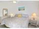 Well-lit bedroom featuring a ceiling fan, a queen bed, and white wicker furniture at 206B 56Th Ave. N, North Myrtle Beach, SC 29582