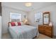 Cozy bedroom featuring a queen bed with a dresser and warm natural lighting at 206B 56Th Ave. N, North Myrtle Beach, SC 29582