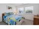 Cozy bedroom with two windows, light gray carpet, a blue quilt, and light wood furniture at 206B 56Th Ave. N, North Myrtle Beach, SC 29582
