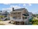 Charming beach home with a neutral color palette, white trim, deck, and low-maintenance yard at 206B 56Th Ave. N, North Myrtle Beach, SC 29582