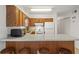 Bright kitchen features wood cabinets, white appliances, breakfast bar with seating, and ample counter space at 206B 56Th Ave. N, North Myrtle Beach, SC 29582