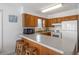 Kitchen features wooden cabinetry, bar-style seating, and a full-size refrigerator at 206B 56Th Ave. N, North Myrtle Beach, SC 29582