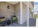 Relaxing front porch with shingle siding, seating, and ambient lighting at 206B 56Th Ave. N, North Myrtle Beach, SC 29582