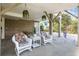 Inviting covered patio featuring rocking chairs, hanging plants, and a relaxing atmosphere at 206B 56Th Ave. N, North Myrtle Beach, SC 29582