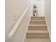 Carpeted staircase with white railings leads to the upper level of the home at 206B 56Th Ave. N, North Myrtle Beach, SC 29582