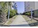 Public walkway leading towards the beach between condominiums and lush greenery at 206B 56Th Ave. N, North Myrtle Beach, SC 29582