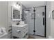 Bathroom featuring a framed glass shower with a white vanity and modern fixtures at 214 2Nd Ave. S, North Myrtle Beach, SC 29582