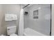 Modern bathroom featuring a tiled shower with built-in shelves and a toilet at 214 2Nd Ave. S, North Myrtle Beach, SC 29582