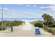 View of sandy beach access to the ocean over the dunes on a sunny day with blue skies at 214 2Nd Ave. S, North Myrtle Beach, SC 29582