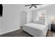 Bright bedroom with white walls, wood-look floors, ceiling fan, and white bed at 214 2Nd Ave. S, North Myrtle Beach, SC 29582