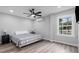 A cozy bedroom with a queen bed, ceiling fan, and natural light from a large window at 214 2Nd Ave. S, North Myrtle Beach, SC 29582
