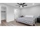 Bedroom features a queen bed with bedside tables, ceiling fan, and closet with sliding door at 214 2Nd Ave. S, North Myrtle Beach, SC 29582