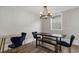 The dining area features a black table with bench seating and navy velvet chairs under a chandelier at 214 2Nd Ave. S, North Myrtle Beach, SC 29582