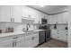 Modern kitchen with white cabinets, stainless steel appliances, and stylish countertops at 214 2Nd Ave. S, North Myrtle Beach, SC 29582