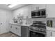 Modern kitchen with white cabinets, stainless steel appliances, and stylish countertops at 214 2Nd Ave. S, North Myrtle Beach, SC 29582