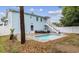 Backyard featuring a pool with lounge area, steps to second floor and white privacy fence at 214 2Nd Ave. S, North Myrtle Beach, SC 29582