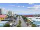 Street view of a beach town showcasing palm trees, buildings, shops and the ocean in the distance at 214 2Nd Ave. S, North Myrtle Beach, SC 29582