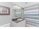 Bathroom features a single sink vanity with granite countertops and blue striped shower curtain at 2151 Bridge View Ct. # 1-803, North Myrtle Beach, SC 29582