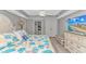 The primary bedroom has a beach theme, complemented by a dresser with a television and private bath access at 2151 Bridge View Ct. # 1-803, North Myrtle Beach, SC 29582